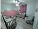 Inviting Bedroom featuring a crib, comfortable recliner, and soft color palette at 17328 W Pinnacle Vista Dr Dr, Surprise, AZ 85387