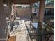 Covered patio area with a dining set, grill, and an open view to the backyard for outdoor enjoyment at 17328 W Pinnacle Vista Dr Dr, Surprise, AZ 85387