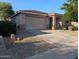 Charming home featuring a neutral color palette, a two-car garage, and a well-manicured desert landscape at 17328 W Pinnacle Vista Dr Dr, Surprise, AZ 85387