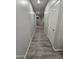 Hallway featuring gray walls and wood-look vinyl flooring, leading to rooms with archways and niches at 17328 W Pinnacle Vista Dr Dr, Surprise, AZ 85387