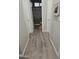Bright hallway with white doors, wood-look floors, and access to a bathroom at 17328 W Pinnacle Vista Dr Dr, Surprise, AZ 85387