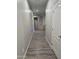 Hallway featuring gray walls and wood-look vinyl flooring, leading to rooms with archways and niches at 17328 W Pinnacle Vista Dr Dr, Surprise, AZ 85387