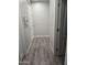 Well-lit hallway with neutral walls and wood-look floors, leading to various rooms at 17328 W Pinnacle Vista Dr Dr, Surprise, AZ 85387