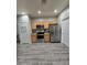 Well-lit kitchen with wood cabinets, stainless steel appliances, and hardwood flooring at 17328 W Pinnacle Vista Dr Dr, Surprise, AZ 85387