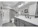 Modern bathroom featuring a vanity with sleek fixtures, a large mirror, and a shower-tub combination at 17815 W Straight Arrow Ln, Surprise, AZ 85387