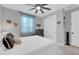 Neutral bedroom with a large ceiling fan, comfortable bed with decorative pillows, and a closet with sliding doors at 17815 W Straight Arrow Ln, Surprise, AZ 85387