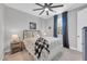 Cozy bedroom with a patterned bed, blue curtains, and a nightstand, creating a comfortable and inviting space at 17815 W Straight Arrow Ln, Surprise, AZ 85387