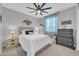 Well-lit bedroom with a large bed, stylish decor, and a ceiling fan for added comfort at 17815 W Straight Arrow Ln, Surprise, AZ 85387