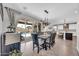 Open-concept dining area with views of the pool, kitchen, and living space with modern decor at 17815 W Straight Arrow Ln, Surprise, AZ 85387