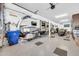 Large garage featuring epoxy flooring, RV parking, and extra room for a motorcycle and other vehicles at 17815 W Straight Arrow Ln, Surprise, AZ 85387