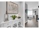Hallway featuring a white cabinet, stylish artwork, and a glimpse of the living room at 17815 W Straight Arrow Ln, Surprise, AZ 85387