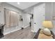 Hallway with hardwood flooring, wall decor and a door leading to other rooms at 17815 W Straight Arrow Ln, Surprise, AZ 85387