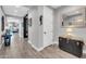 Clean hallway features modern flooring with decorative mirror and lamp at 17815 W Straight Arrow Ln, Surprise, AZ 85387
