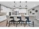 Stylish kitchen island with pendant lighting and barstool seating at 17815 W Straight Arrow Ln, Surprise, AZ 85387