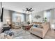 Inviting living room showcases neutral tones and plush seating under modern ceiling fan at 17815 W Straight Arrow Ln, Surprise, AZ 85387