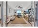 Versatile living room with a comfortable couch, a ceiling fan, and a dedicated workspace at 17815 W Straight Arrow Ln, Surprise, AZ 85387