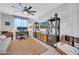 Versatile living room with a comfortable couch, a ceiling fan, a dedicated workspace, and wood entertainment center at 17815 W Straight Arrow Ln, Surprise, AZ 85387