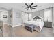 Spacious main bedroom featuring a ceiling fan, barn door to the bathroom, and ample natural light at 17815 W Straight Arrow Ln, Surprise, AZ 85387