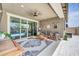 Cozy covered patio featuring comfortable seating, ceiling fan, and sliding glass doors at 17815 W Straight Arrow Ln, Surprise, AZ 85387