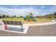 Community playground with colorful play structures, a bench, and lush green surroundings, perfect for Gathering fun at 17815 W Straight Arrow Ln, Surprise, AZ 85387