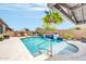 Backyard pool area with water features and landscaping under a sunny sky at 17815 W Straight Arrow Ln, Surprise, AZ 85387