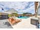 Well landscaped backyard with a covered dining, pool and waterfall feature at 17815 W Straight Arrow Ln, Surprise, AZ 85387