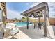 Inviting backyard pool area with a covered patio, dining set, and lounge seating at 17815 W Straight Arrow Ln, Surprise, AZ 85387