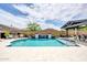 Beautiful pool with a waterfall feature and a covered seating area, perfect for outdoor relaxation at 17815 W Straight Arrow Ln, Surprise, AZ 85387