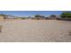 Expansive gravel backyard offers a blank canvas for landscaping and outdoor living at 20761 N Herbert Ave, Maricopa, AZ 85138