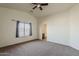 Bright bedroom featuring a vaulted ceiling, soft natural light, and neutral carpeting at 20761 N Herbert Ave, Maricopa, AZ 85138