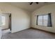 Spacious carpeted bedroom with a vaulted ceiling and natural light from the window at 20761 N Herbert Ave, Maricopa, AZ 85138