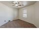 Bedroom with neutral colored carpet, ceiling fan, and a window at 20761 N Herbert Ave, Maricopa, AZ 85138
