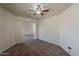 Carpeted bedroom features a ceiling fan and an open doorway at 20761 N Herbert Ave, Maricopa, AZ 85138