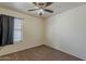 Bedroom with neutral colored carpet, ceiling fan, and a window at 20761 N Herbert Ave, Maricopa, AZ 85138