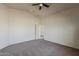 Large carpeted bedroom with vaulted ceiling, neutral walls, and ample natural light at 20761 N Herbert Ave, Maricopa, AZ 85138