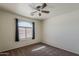 Neutral bedroom featuring a ceiling fan and a window with blinds at 20761 N Herbert Ave, Maricopa, AZ 85138