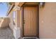 Inviting front door with a decorative light fixture and manicured landscaping at 20761 N Herbert Ave, Maricopa, AZ 85138