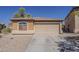 Charming single-story home featuring a two car garage, neutral paint, and a well-maintained front yard at 20761 N Herbert Ave, Maricopa, AZ 85138