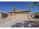 Charming single-story home featuring a two car garage, neutral paint, and a low maintenance front yard at 20761 N Herbert Ave, Maricopa, AZ 85138