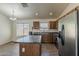 Bright kitchen featuring a center island, stainless steel appliances, and lots of natural light from multiple windows at 20761 N Herbert Ave, Maricopa, AZ 85138