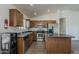 Well-equipped kitchen with wood cabinets, stainless steel appliances, and a convenient center island at 20761 N Herbert Ave, Maricopa, AZ 85138