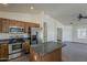Open kitchen with stainless steel appliances, center island, and ample cabinet space, perfect for cooking and entertaining at 20761 N Herbert Ave, Maricopa, AZ 85138