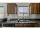 Kitchen sink with a view, complemented by dark wood cabinetry and modern fixtures at 20761 N Herbert Ave, Maricopa, AZ 85138