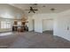 Bright, open-concept living room with tile entry, vaulted ceiling and kitchen view at 20761 N Herbert Ave, Maricopa, AZ 85138