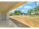 Large backyard with concrete patio and detached carport at 2148 W Hayward Ave, Phoenix, AZ 85021