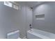 Updated bathroom with white tiled tub and convenient shower niche at 2148 W Hayward Ave, Phoenix, AZ 85021
