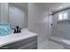 Bathroom with updated vanity, sink, mirror, and walk-in shower at 2148 W Hayward Ave, Phoenix, AZ 85021