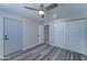 Bedroom features ceiling fan, and closet with neutral paint and modern flooring at 2148 W Hayward Ave, Phoenix, AZ 85021