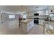 Open concept kitchen with granite counters, white cabinets, stainless appliances, and an island at 2148 W Hayward Ave, Phoenix, AZ 85021