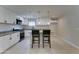 Modern kitchen featuring granite countertops, white cabinets, and a center island with seating at 2148 W Hayward Ave, Phoenix, AZ 85021